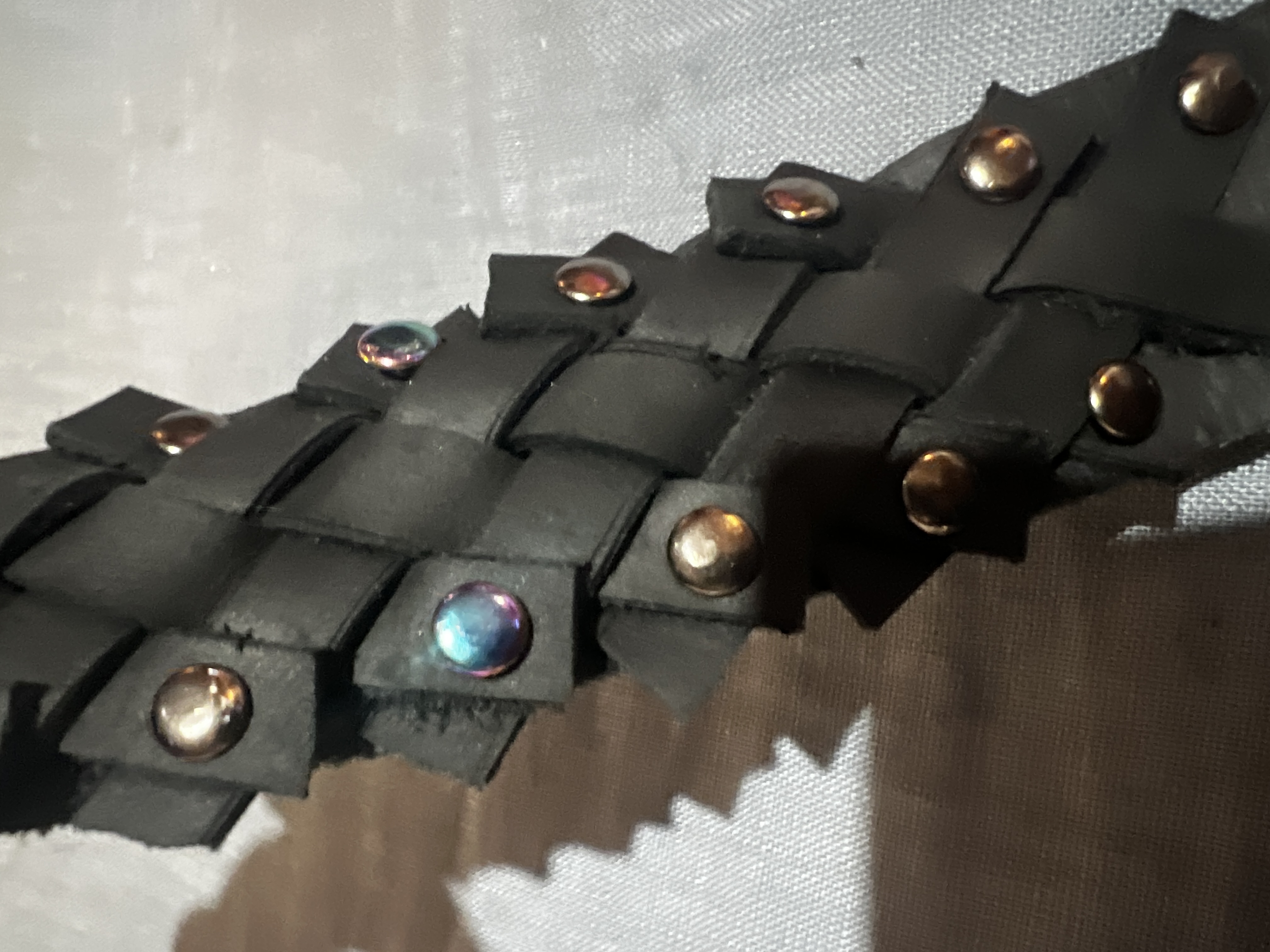 black matte weave with rainbow and gunmetal rivets